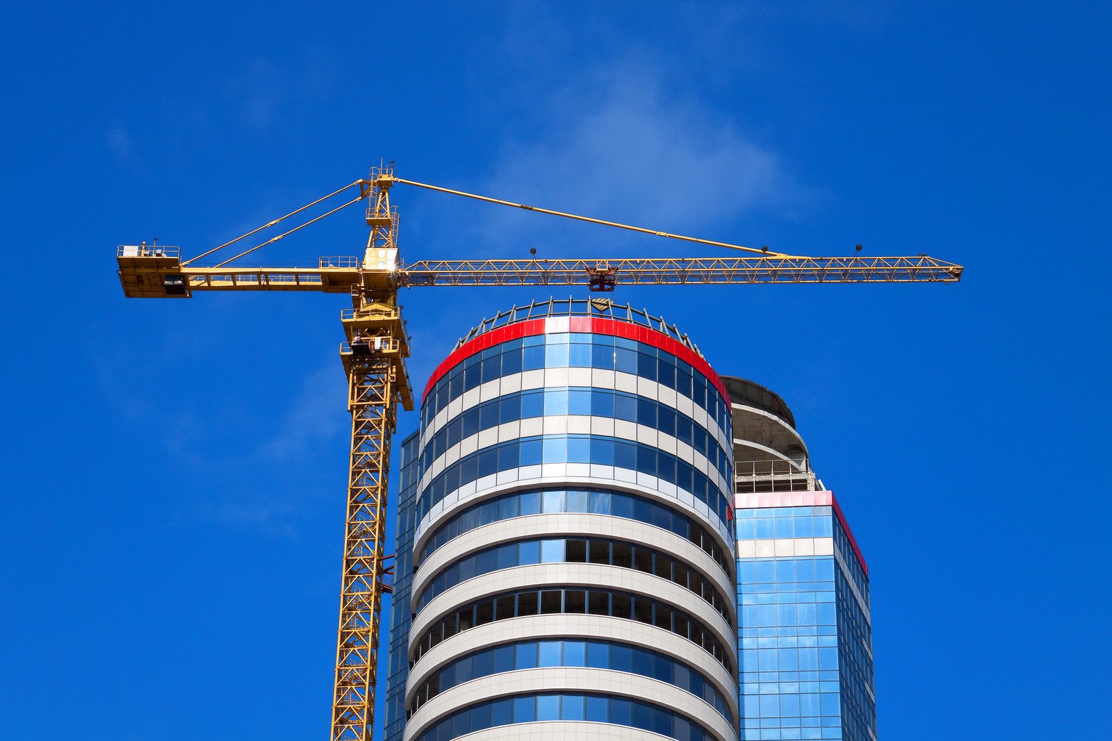 aluminium panels for construction showing a high rise circular building with crane